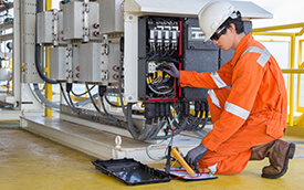 man doing maintenance on an industrial machine