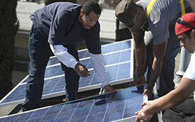 people installing solar panels